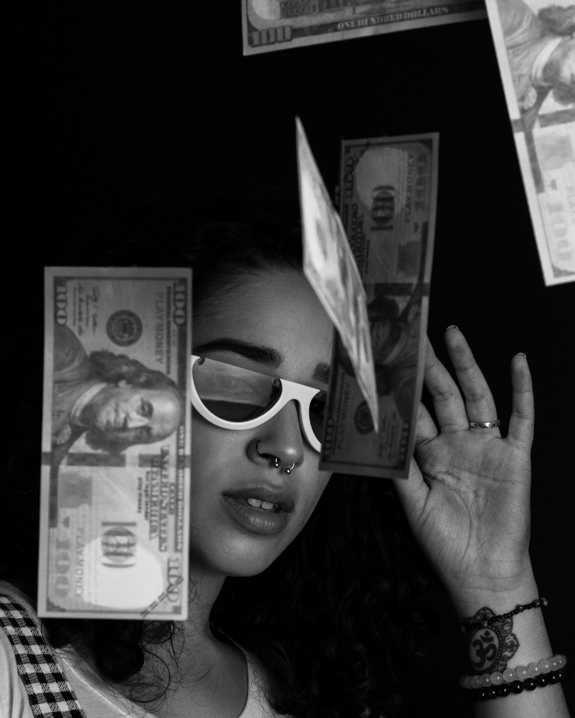 Grayscale Photography of a Woman Throwing 100 US Dollar Banknotes on Air